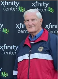 Man at Xfinity Center in red-blue jacket