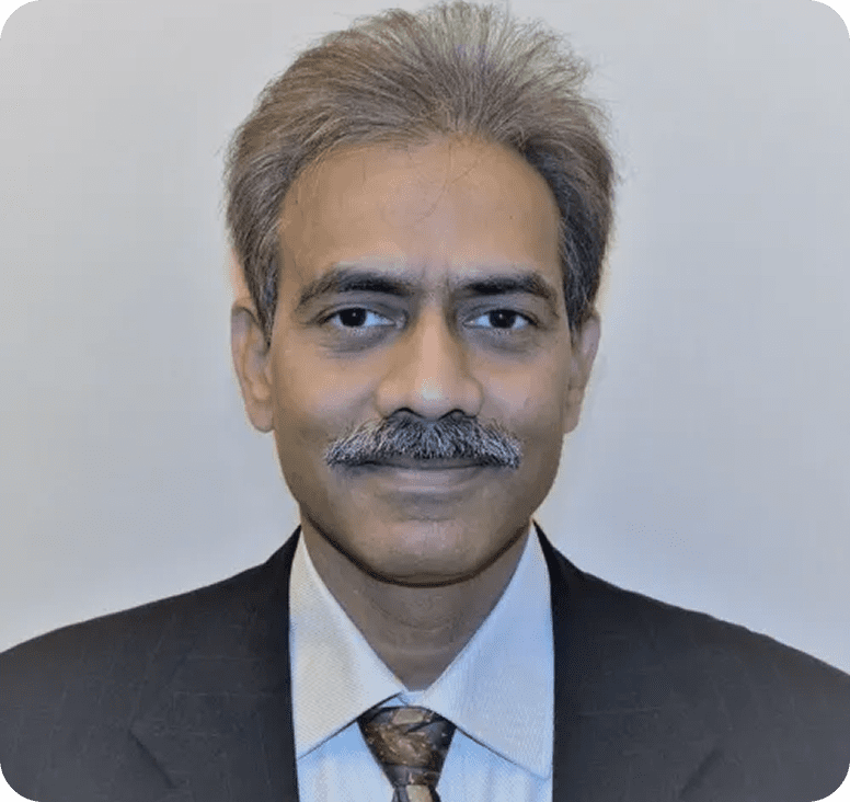 Man in suit with gray hair and mustache