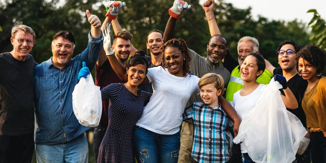 Diverse volunteers holding trash bags