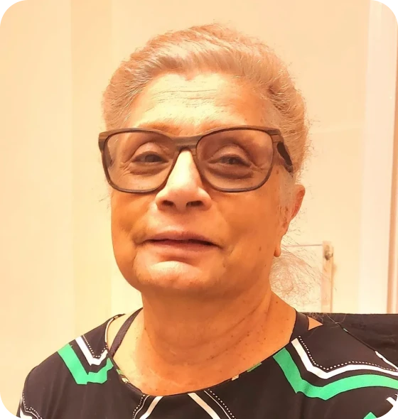 Senior wearing patterned blouse and glasses