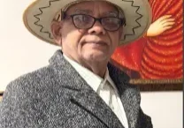 Elderly man with glasses, hat, gray coat