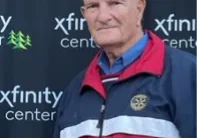 Man at Xfinity Center in red-blue jacket