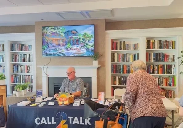 Man at information table in library